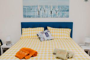 a bed with a blue headboard and two pillows at I due ponti in Molfetta
