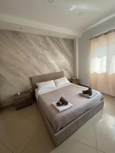 a bedroom with a bed with two towels on it at Casa vacanza Helios in Leonforte