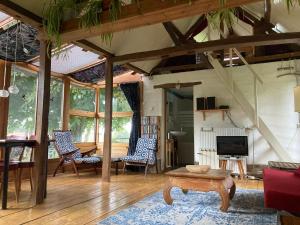 a living room with a table and chairs at The charming, bright stable in Neuilly-le-Dien
