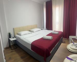 a bedroom with a large bed with red curtains at Balat Life Suites in Istanbul +16 photos