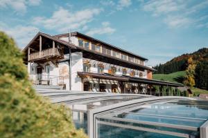 a villa with a swimming pool and a house at Mondseeblick Apartment KG in Innerschwand