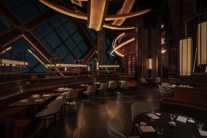 a restaurant with tables and chairs and a chandelier at One&Only One Za'abeel in Dubai