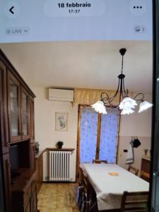 a kitchen with a table and a dining room with a table and chairs at appartamento yuliet in Città di Castello