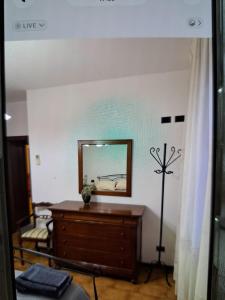 a room with a dresser and a mirror on the wall at appartamento yuliet in Città di Castello