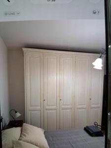 a bedroom with a white closet and a bed at appartamento yuliet in Città di Castello +8 photos