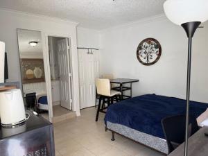 a bedroom with a bed and a table in it at My Garden in Miami Florida in Palmetto Bay