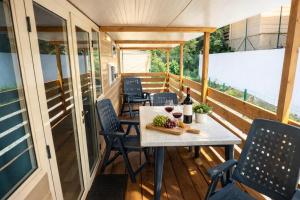 a tiny house with a table and chairs on a balcony at Top Village in Cogoleto