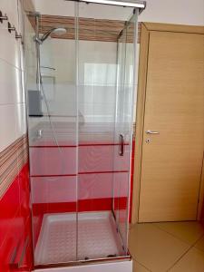 a shower with a glass door in a bathroom at Casa vacanza Helios in Leonforte +26 photos