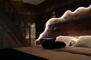 a person laying on a bed in a room at Cabin 13 Immersive Suite with Balneotherapy in Boulogne-sur-Mer