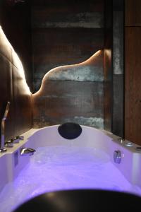 a bath tub in a bathroom with a large window at Cabin 13 Immersive Suite with Balneotherapy in Boulogne-sur-Mer