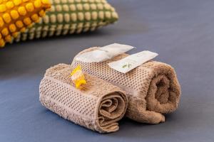a towel shaped like an airplane on a table at Aura Apartment - VISTA LAGO - CENTRO STORICO in Bracciano +31 photos