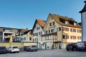 a group of cars parked in front of a building at Hotel Schiff in Horn