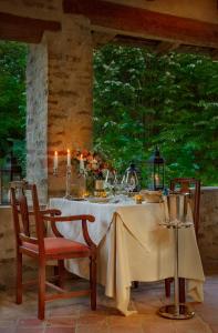 a table with a white table cloth and two chairs at Hotel Castello Di Sinio in Sinio