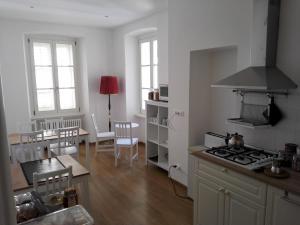 a kitchen with a stove top oven next to a table at Palazzo Brigido Apartment in Trieste