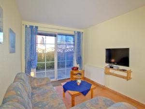 a living room with a couch and a flat screen tv at Villa Lisa in Glowe