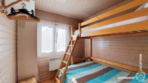 a bunk bed in a sauna with a ladder at Chalet de la Gougère 4 in Chambon-sur-Lac