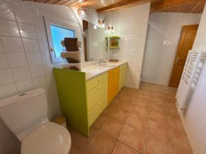 a bathroom with a toilet and a sink at Gîte Le 1935 Évasion en Ardèche, au cœur de la campagne, idéal pour balades à vélo et moto in Saint-Sylvestre