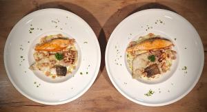 zwei Teller mit Essen auf einem Holztisch in der Unterkunft Haus Chresten in Büllingen