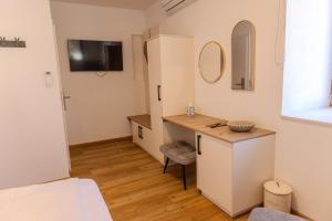 a small room with a desk and a mirror at Chaplin in Kempten +103 photos