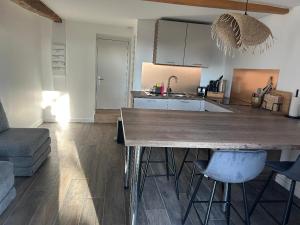 a kitchen with a large wooden table and chairs at Les Granges Dorées in Châtillon