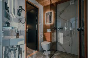a bathroom with a toilet and a glass shower at Luxury Resort Reiu in Reiu +14 photos