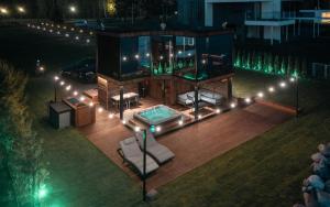 a house with a pool and a deck at night at Luxury Resort Reiu in Reiu
