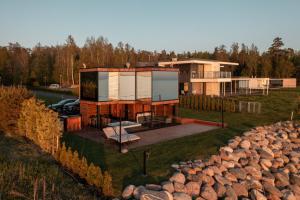 a house on a hill with a large pile of logs at Luxury Resort Reiu in Reiu