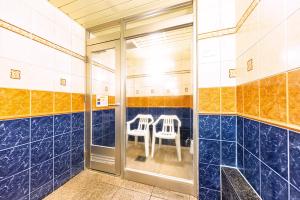 two chairs in a bathroom with blue tiles at Hotel Shiro No Kyuden in Ibaraki