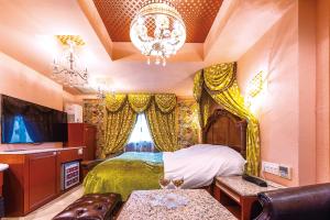 a bedroom with a bed and a chandelier at Hotel Shiro No Kyuden in Ibaraki