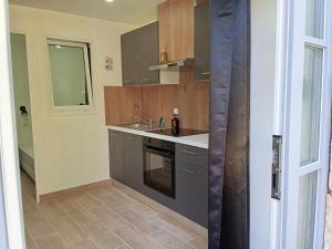 a small kitchen with a sink and a stove at EVASION LOUE #5 x2 people "La POTERIE" in Lods +13 photos