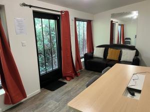 a living room with a table and a couch at T2 Côté Jardin in Eysines