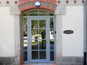a door to a building with a person standing inside at EVASION LOUE #5 x2 people "La POTERIE" in Lods