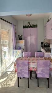 a kitchen with a purple table and purple chairs at Mary's Apartment - Close to port, beaches in Kos