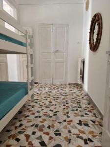 a bedroom with a bunk bed and a tiled floor at IN CENTRO apartments in Torre Maggiore +12 photos