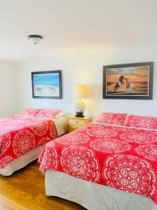 a bedroom with two beds and a picture on the wall at Snug Harbor Marina and Resort in Chincoteague