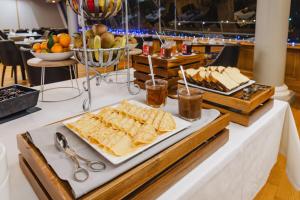 a buffet of food with crackers and fruit on a table at Hotel De La Digue in Le Mont Saint Michel