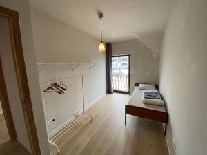 a white room with a bed and a window at Spacious house specially for workers and expats in Maldegem