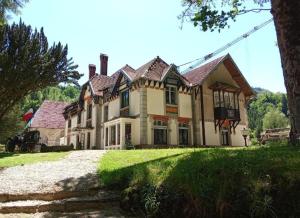 a large house on a grassy yard with a tree at EVASION LOUE #5 x2 people "La POTERIE" in Lods