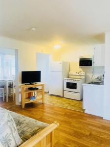 a kitchen with white appliances and a table in a room at Snug Harbor Marina and Resort in Chincoteague
