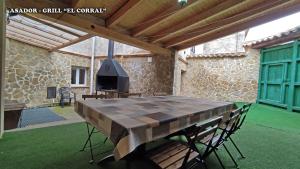 a wooden table with a chess board on a patio at Casa rural L´Amparo -3 espigas- Categoría superior-15 personas in Navarrete del Río