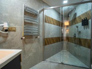 a shower with a glass door in a bathroom at Elite World Comfy Diyarbakır in Diyarbakır