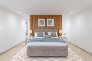 a bedroom with a large bed and two tables at Villa Miramare in Blizikuće