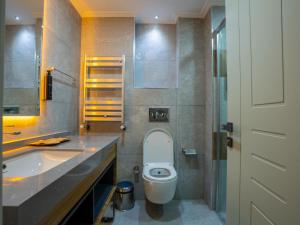 a bathroom with a toilet and a sink at Elite World Comfy Diyarbakır in Diyarbakır