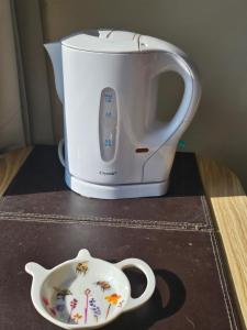 a toaster sitting on top of a counter next to a plate at Shalom, in Saundersfoot, near the sea in Saundersfoot