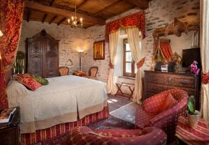 a bedroom with a bed and a chair at Hotel Castello Di Sinio in Sinio +72 photos