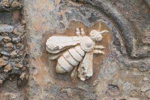a stone sculpture of a bee on a wall at Barberini Guest House Palestrina in Palestrina