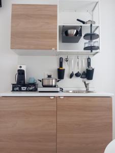 a kitchen with wooden cabinets and a sink at Dimore Fronte Mare affittacamere in Casalbordino +38 photos