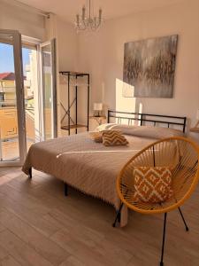 a bedroom with a large bed and a chair at Dimore Fronte Mare affittacamere in Casalbordino