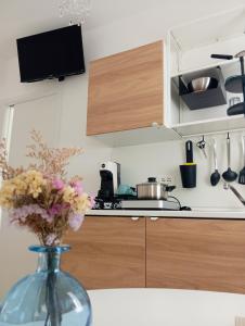 a kitchen with a vase with flowers in it at Dimore Fronte Mare affittacamere in Casalbordino