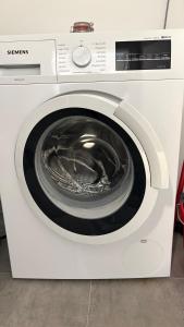 a white washing machine with its door open at Sun Terrace Apartment 04 I Gerlitzen-Ossiachersee I Alpe Maritima in Annenheim